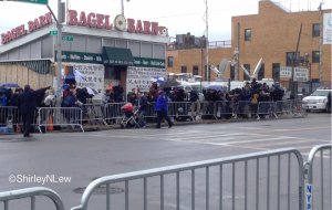 Services for Officer Liu-- Across the street from the funeral home, an out of business bagel shop becomes a corral for the news media. Chinese banners showing support for the Liu family were posted on the windows.