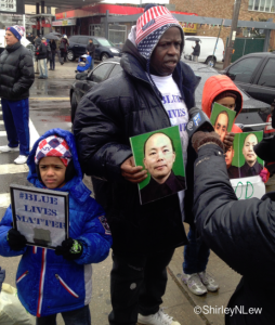Services for Officer Liu: Calvin Hunt and his two children traveled from Manhattan to Brooklyn to show their support for the NYPD