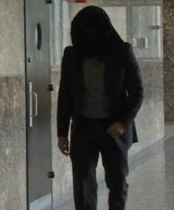 Wojciech Braszczok hides his face outside courtroom
