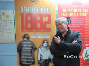 Karlin Chan poses with the 1882 Chinese Exclusion Act traveling exhibit in Manhattan's Chinatown in May 2016.