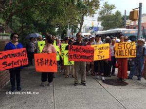 Members of the senior center hold signs to support Tse and his family.