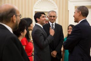 Aneesh Raman with his family greeting President Obama. Raman's hand is on his dad's shoulder